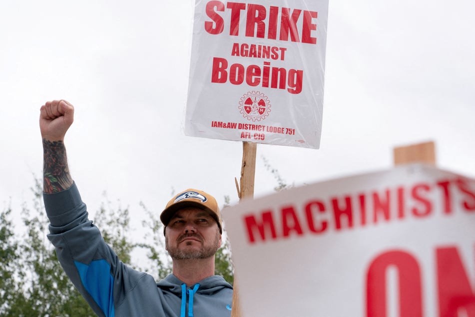 A Boeing worker raises his fist at a picket line during the third day of a strike in Renton, Washington.