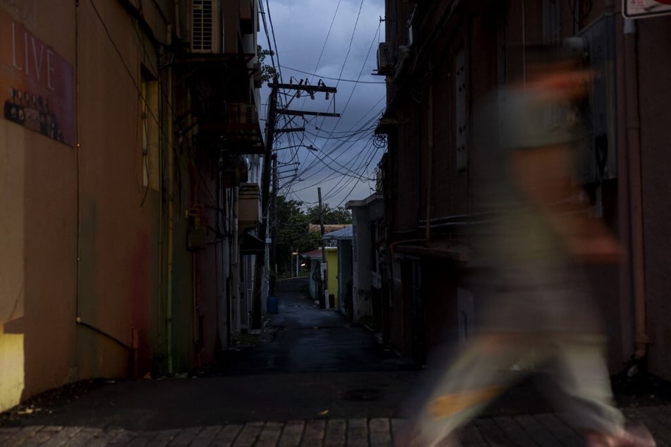 Power and communication lines are seen on a dark street in San Juan, Puerto Rico, after a major power outage hit the island on December 31, 2024.