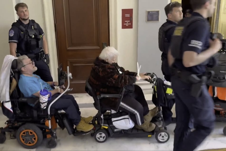 Elderly people in wheelchairs have their wrists zip-tied after protesting Republicans' proposed cuts to Medicaid in the Russell Senate Building.
