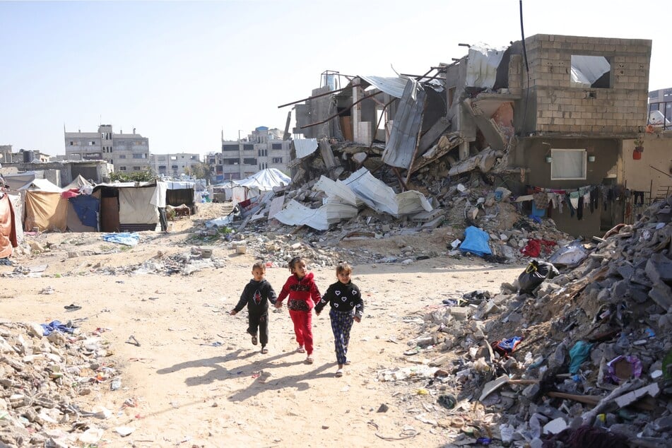Palestinian children play amidst the rubble in Jabalia in the northern Gaza Strip on February 17, 2025.