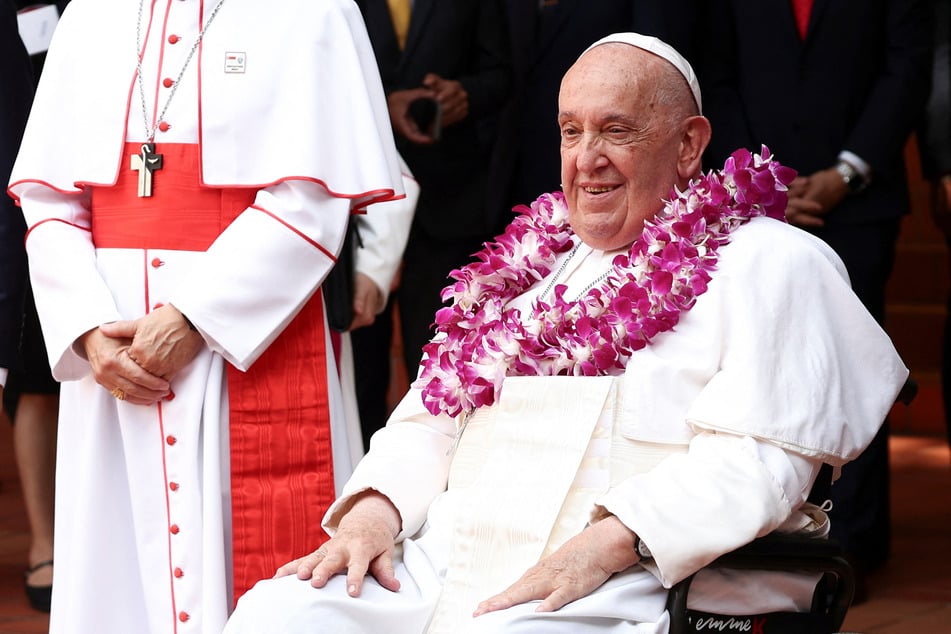 Pope Francis arrives to attend an inter-religious meeting with young people at the Catholic Junior College in Singapore.