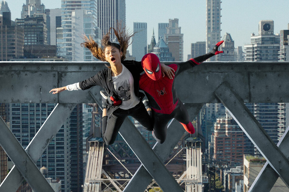 Spider-Man: No Way Home, starring Zendaya (l.) and Tom Holland, is the first film of the Covid-19 era to cross $1 billion.