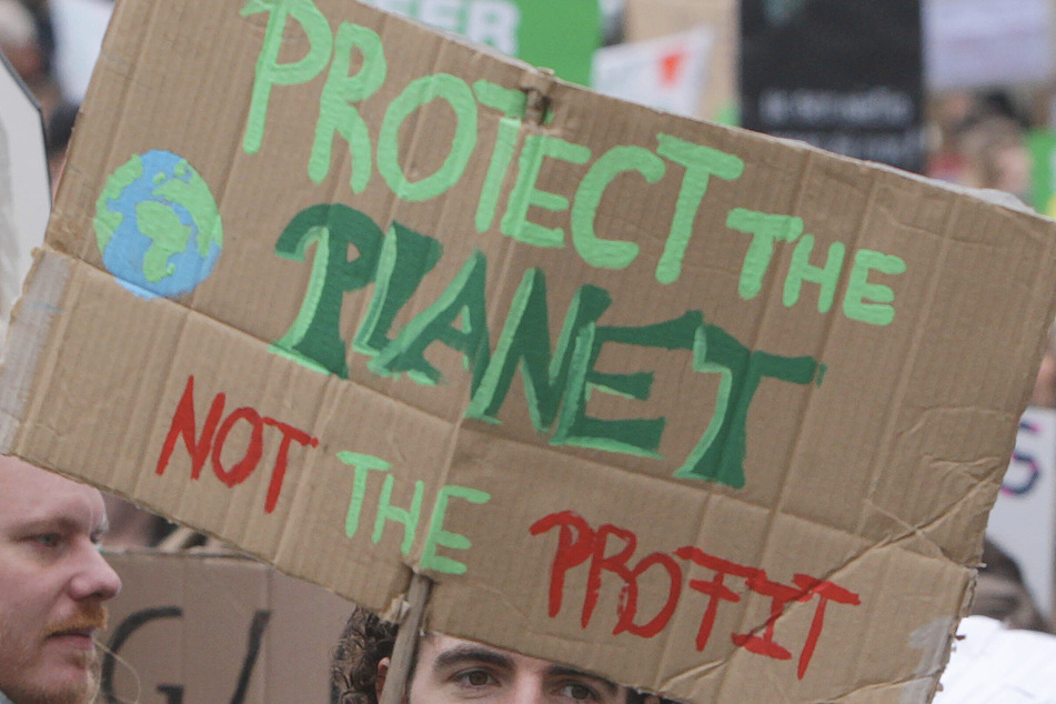 The group of scientists wants ad companies to protect the planet over profits.