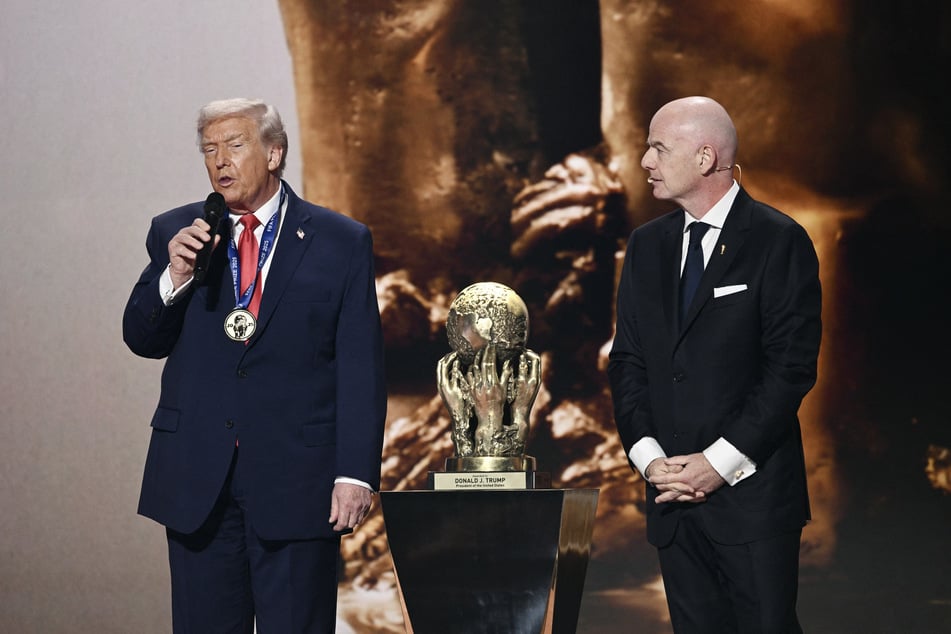 (L-R) US President Donald Trump speaks as he receives the FIFA Peace Prize from FIFA President Gianni Infantino during the draw for the 2026 FIFA Football World Cup taking place in the US, Canada, and Mexico, at the Kennedy Center, in Washington, DC, on Friday.