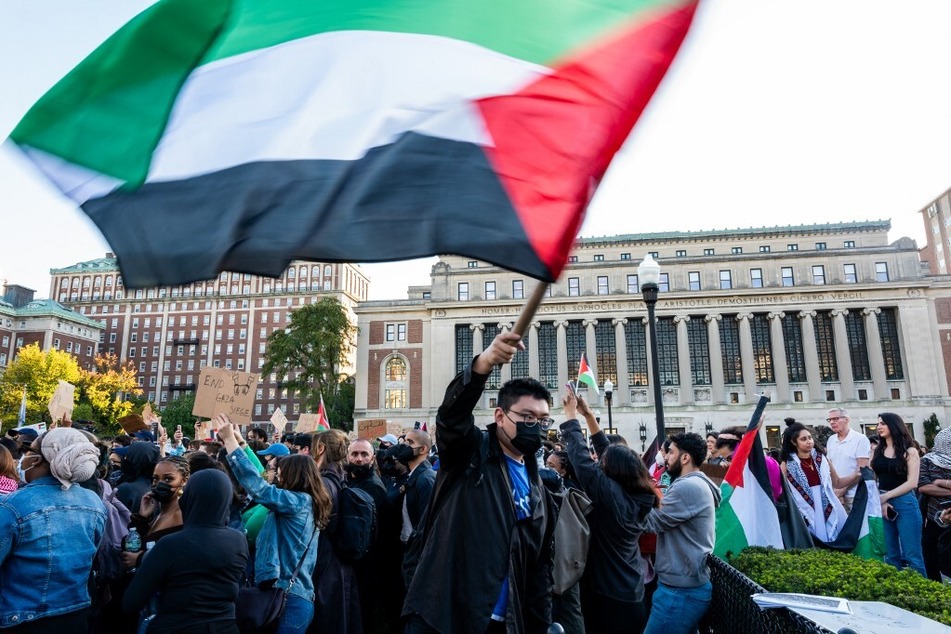 Columbia University students, faculty, and staff wave Palestinian flags during an on-campus protest in solidarity with Gazans under siege.