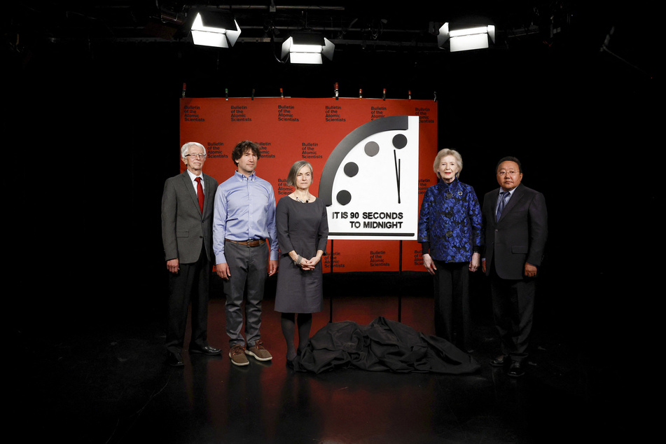 (L-R) Members of the Bulletin of the Atomic Scientists Siegfried S. Hecker, Daniel Holz, Sharon Squassoni, Mary Robinson, and Elbegdorj Tsakhia stand for a photo with the 2023 Doomsday Clock ahead of a live-streamed event on Tuesday.