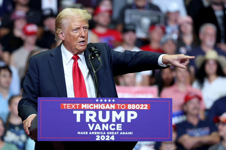 Donald Trump points while delivering remarks during a campaign rally in Grand Rapids, Michigan.