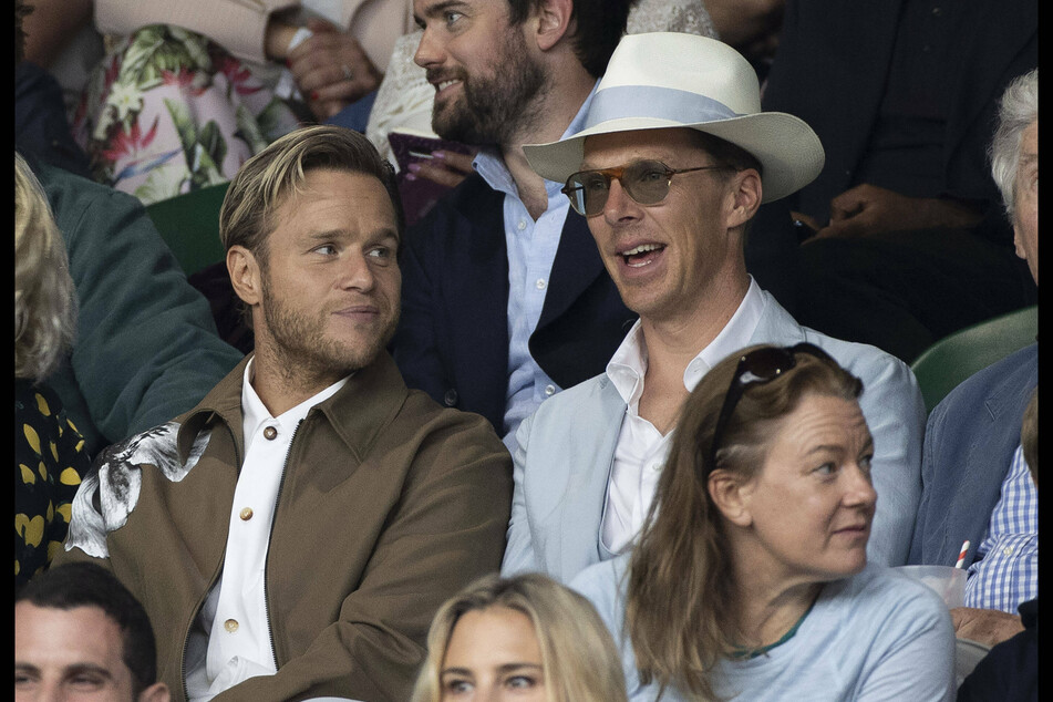 Actor Bendeict Cumberbatch (44, r) sat next to singer Olly Murs (37) in a classy hat.