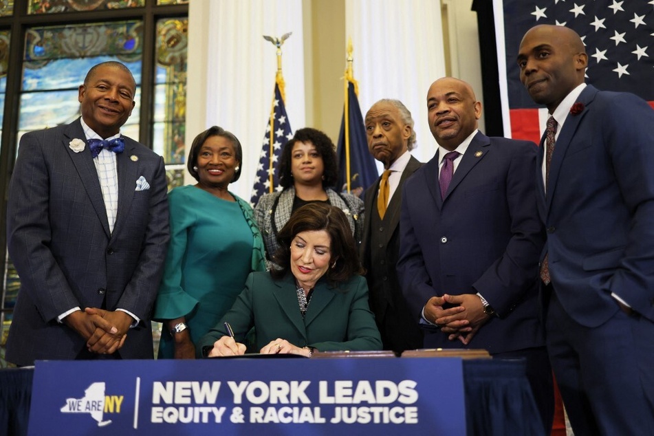 New York Governor Kathy Hochul signs legislation to create a state reparations commission on December 19, 2023.