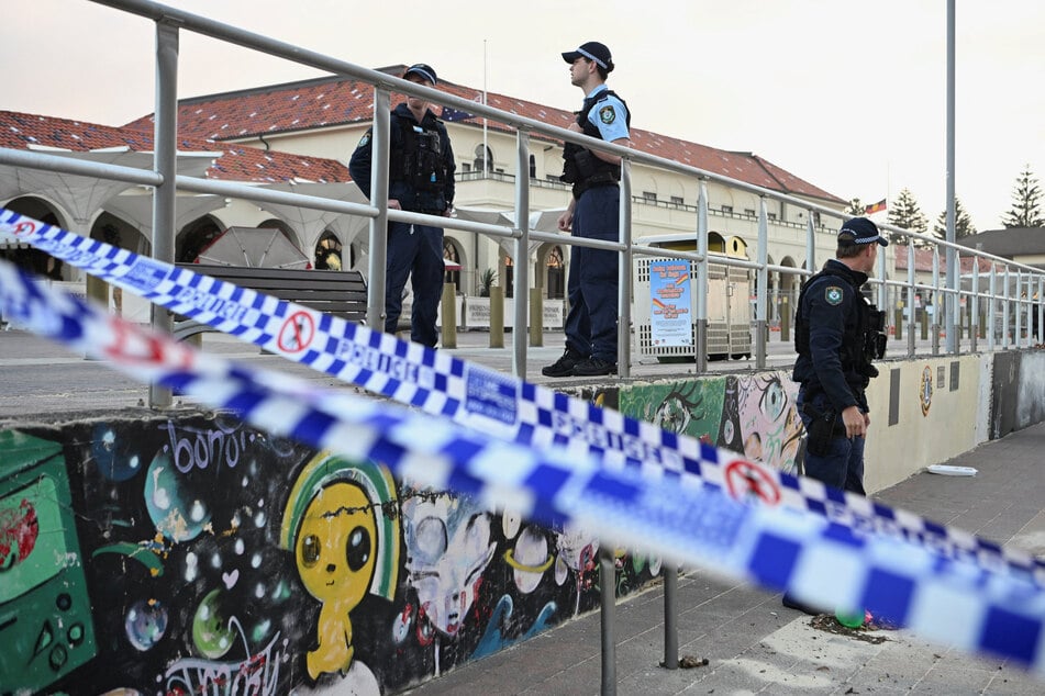 Police officers stand guard following the attack on a Jewish holiday celebration at Sydney's Bondi Beach in Australia on December 15, 2025.