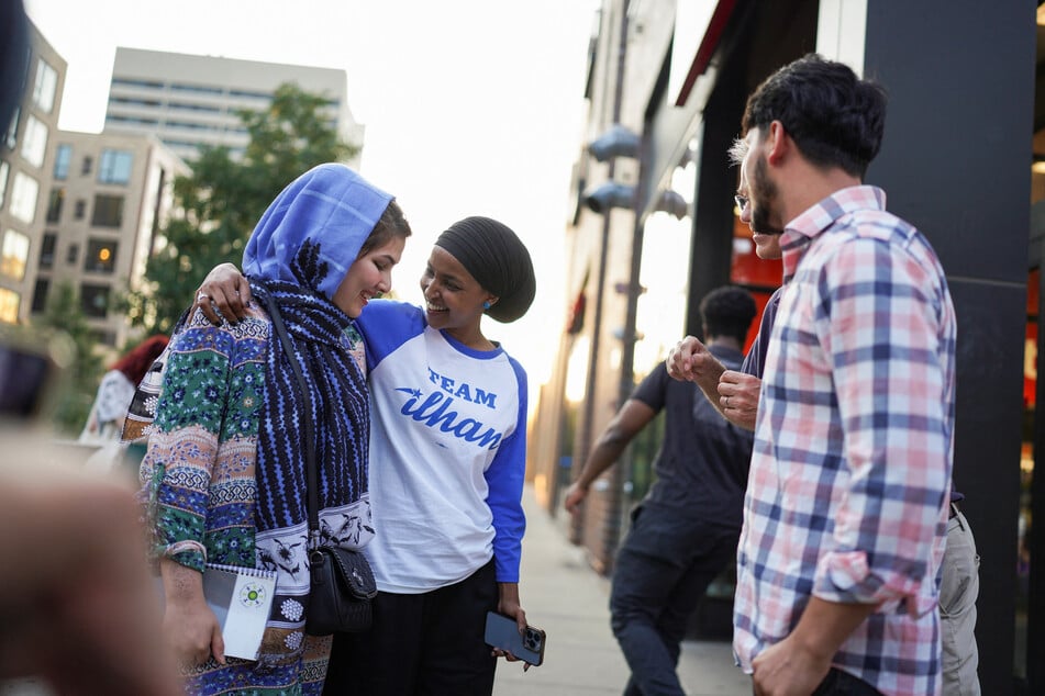 Representative Ilhan Omar greets supporters outside a Target store during primary election day in Minneapolis, Minnesota.