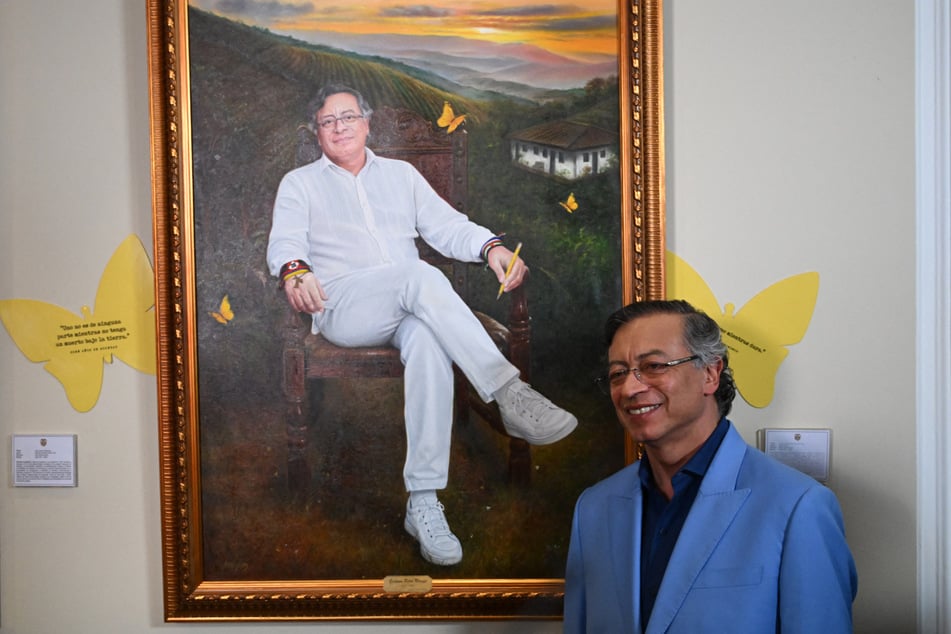 Colombia's President Gustavo Petro poses next to a portrait of himself painted by Colombian artist Jaime Rojas during its unveiling at the Casa de Narino Presidential Palace in Bogota on August 3, 2026.