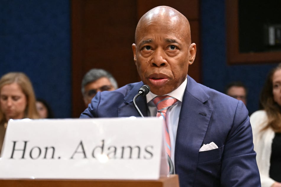 Eric Adams, who is running for another term, denied that his strong line on immigration is connected to the Justice Department's decision to drop criminal charges against him.