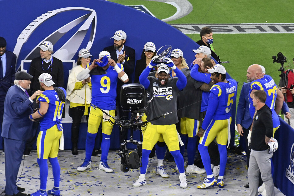 The Rams' Von Miller celebrates with the George Halas Trophy after the win over the 49ers.