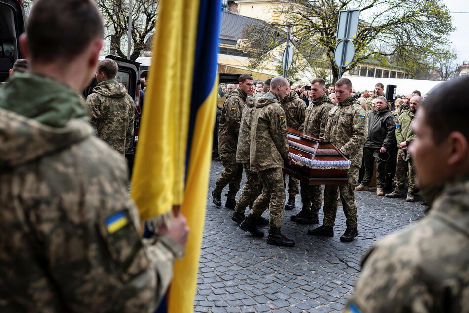 Ukrainian soldiers in Lviv hold a funeral for service members killed in the Luhansk region.