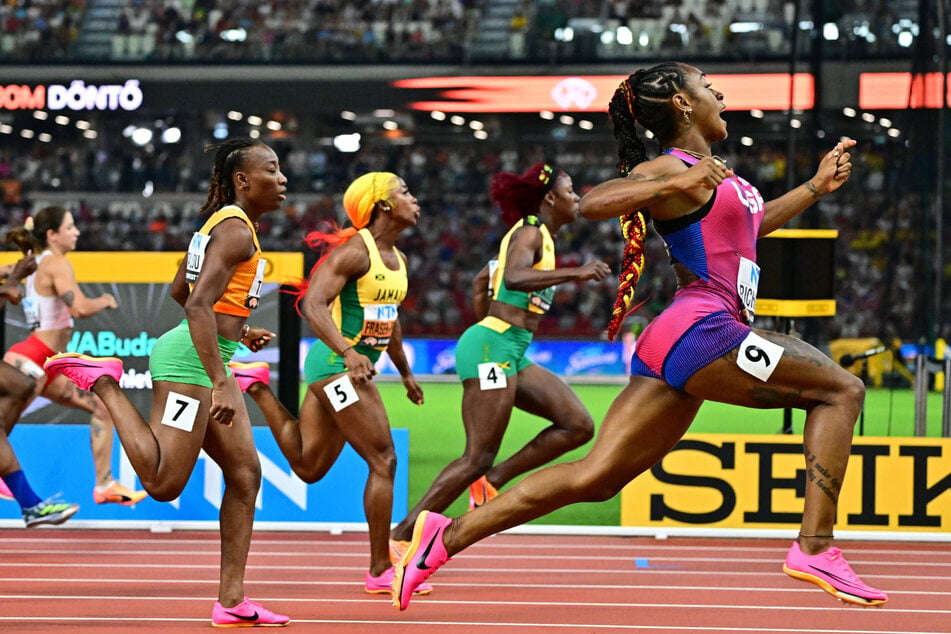 Sha'carri Richardson crosses the line to win the women's 100-meter final.