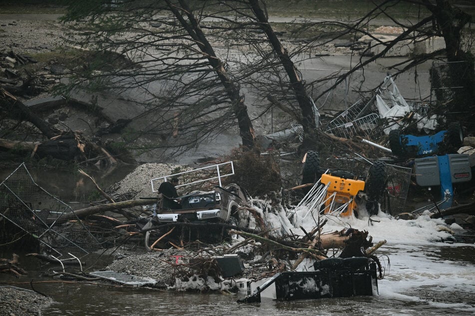 A photo shows overturned vehicles and broken trees after flooding caused by a flash flood at the Guadalupe River in Kerrville, Texas, on Saturday.