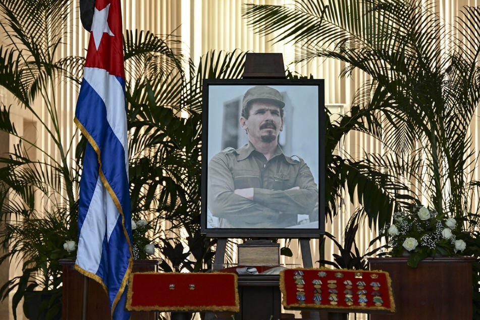 A portrait of Commander Ramiro Valdes stands next to a Cuban national flag during his funeral at the Ministry of the Revolutionary Armed Forces in Havana on June 23, 2026.
