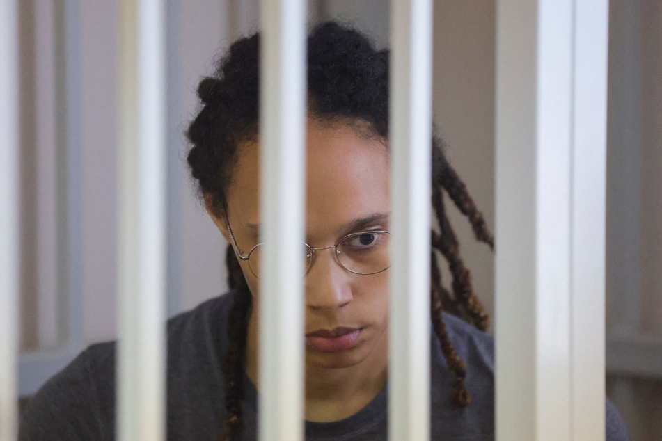 Brittney Griner sits inside a defendants' cage during the reading of the court's verdict in Khimki outside Moscow, Russia.