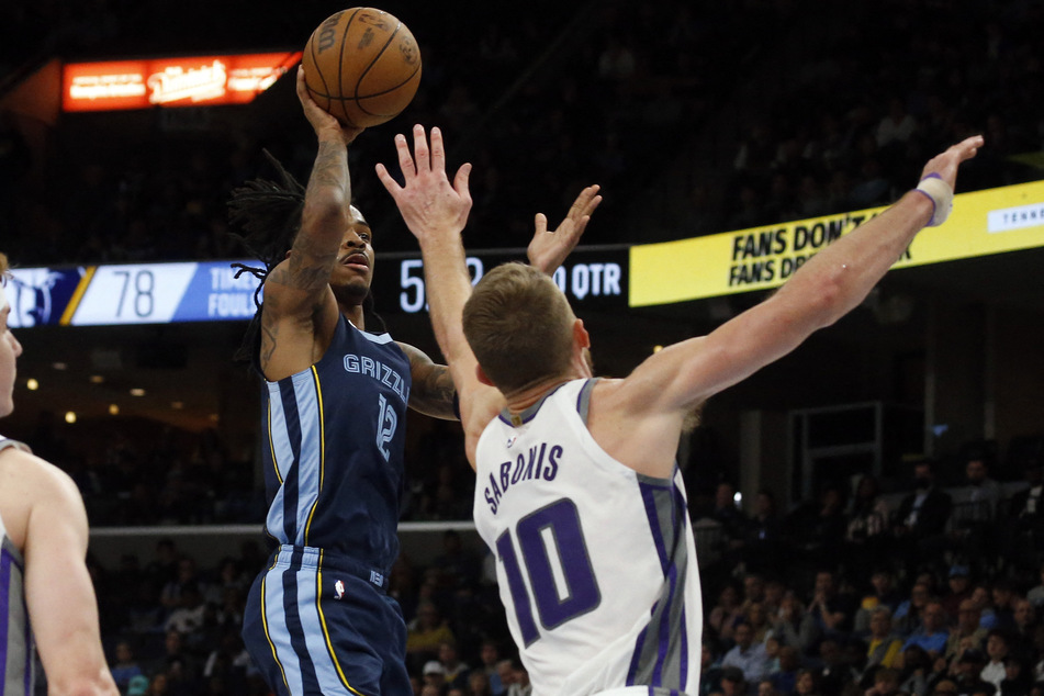 Memphis Grizzlies guard Ja Morant shoots as Sacramento Kings forward Domantas Sabonis defends during the second half at FedExForum.
