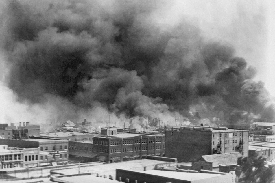 Smoke billows into the sky as a white mob attacks the Greenwood District during the 1921 Tulsa Race Massacre.