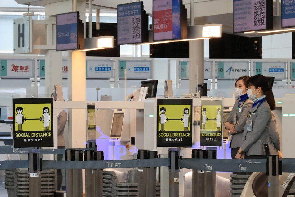 Signs to require social distancing are displayed at the empty international terminal of the Haneda airport in Tokyo, Japan.