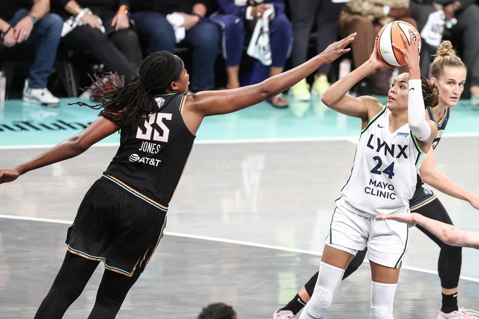 Minnesota Lynx forward Napheesa Collier shoots as New York Liberty forward Jonquel Jones defends in overtime at Barclays Center.