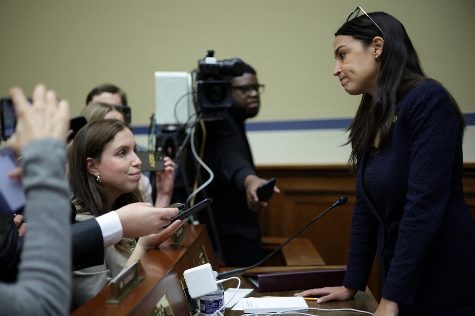 Rep. Alexandria Ocasio-Cortez speaks to the press during a break in the hearing before the House Oversight and Accountability Committee.