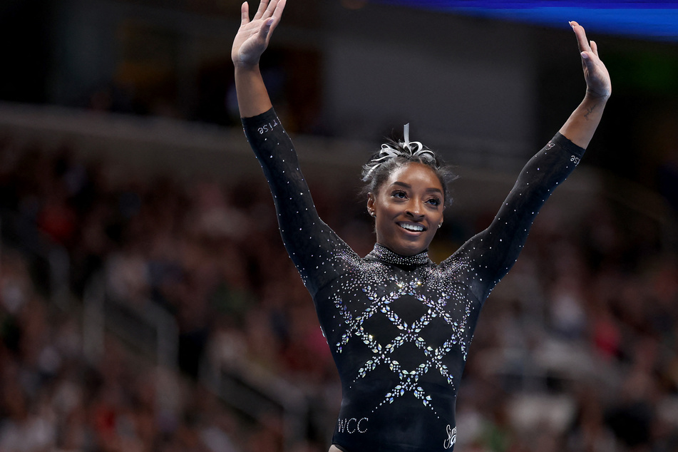 Simone Biles won a record eighth all-around US Championship, sealing the triumph with a floor routine on Sunday.
