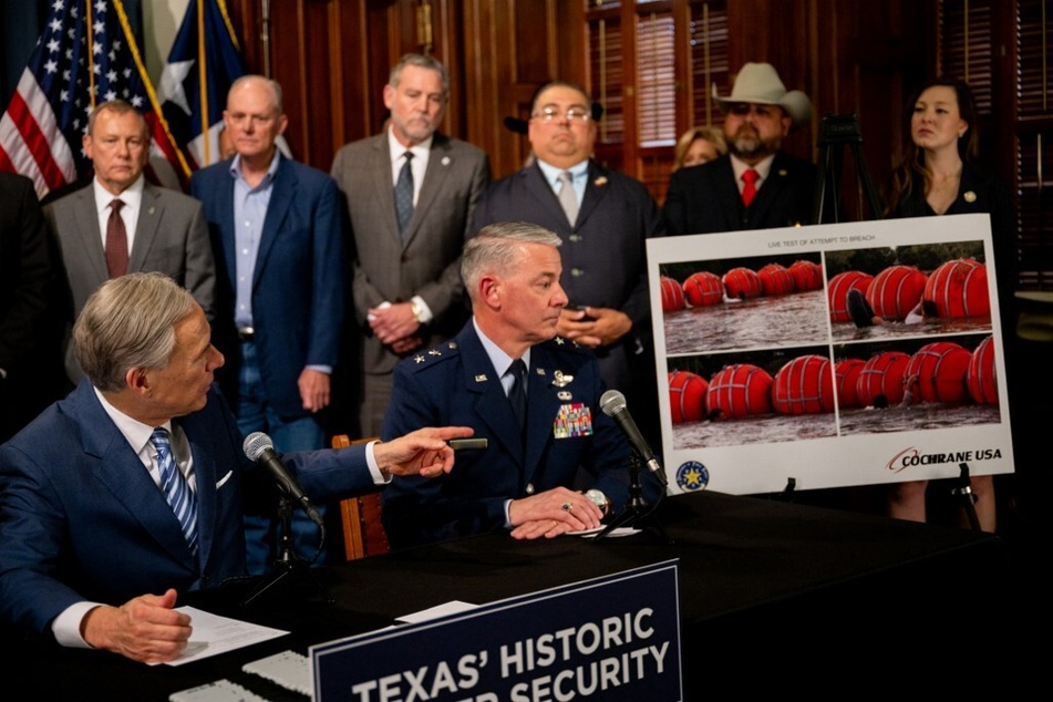 Texas Governor Greg Abbott points to an illustration of the border buoys during a news conference at the Texas State Capitol on June 8, 2023.