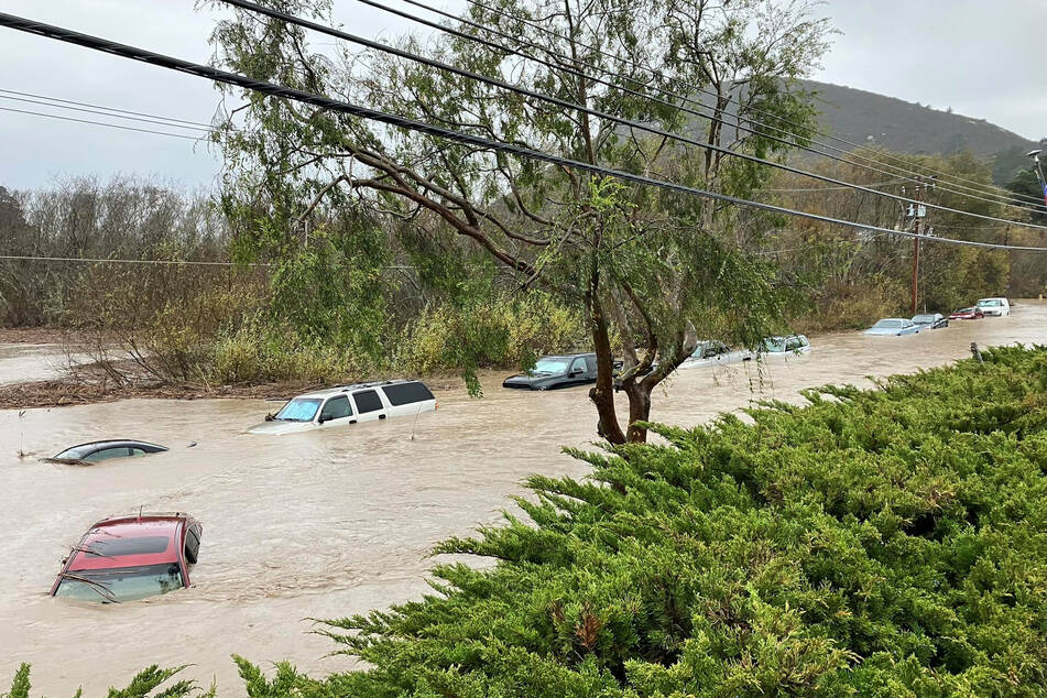 Cars are seen submerged in flood waters in Morro Bay, California.