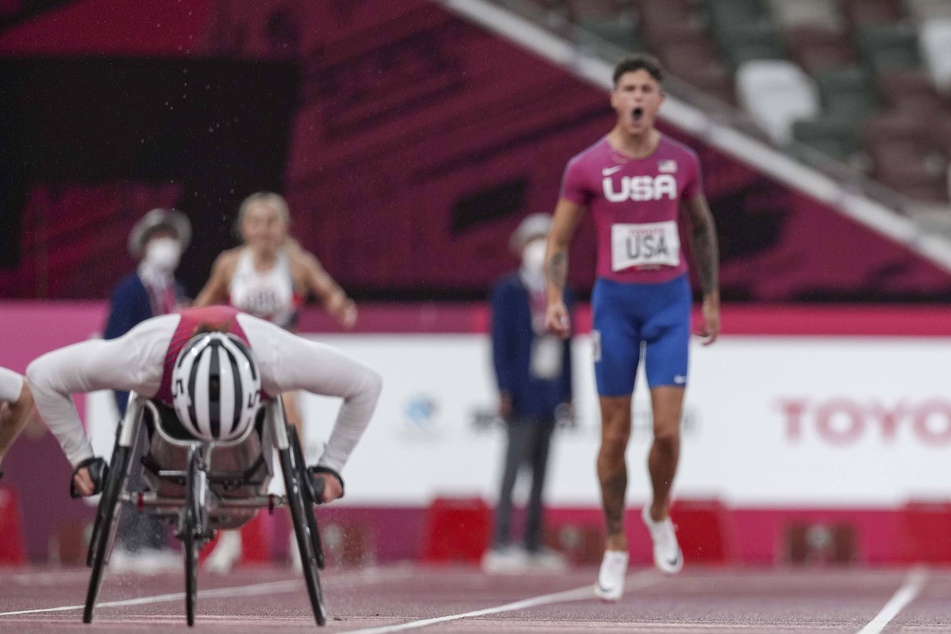 Nick Mayhugh (r.) cheered for relay teammate Tatyana McFadden (l.) in the 4x100-meter universal relay on Friday.