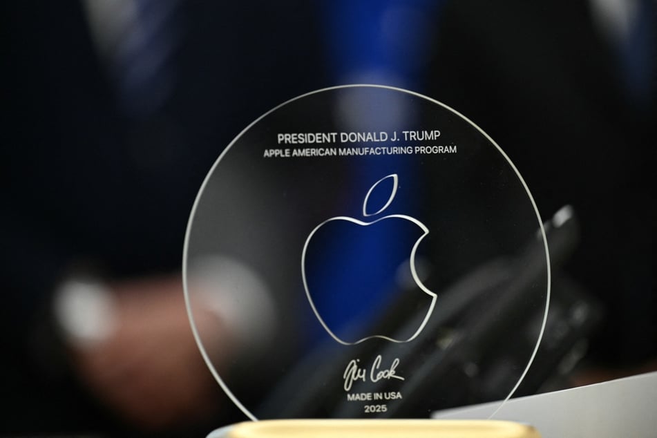 A memento presented by Apple CEO Tim Cook is pictured on the Resolute Desk in the Oval Office of the White House on August 6, 2025.
