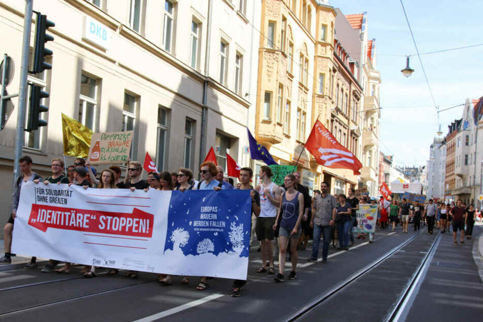 Mit Transparenten ziehen die Gegendemonstranten durch die Hallesche Innenstadt.
