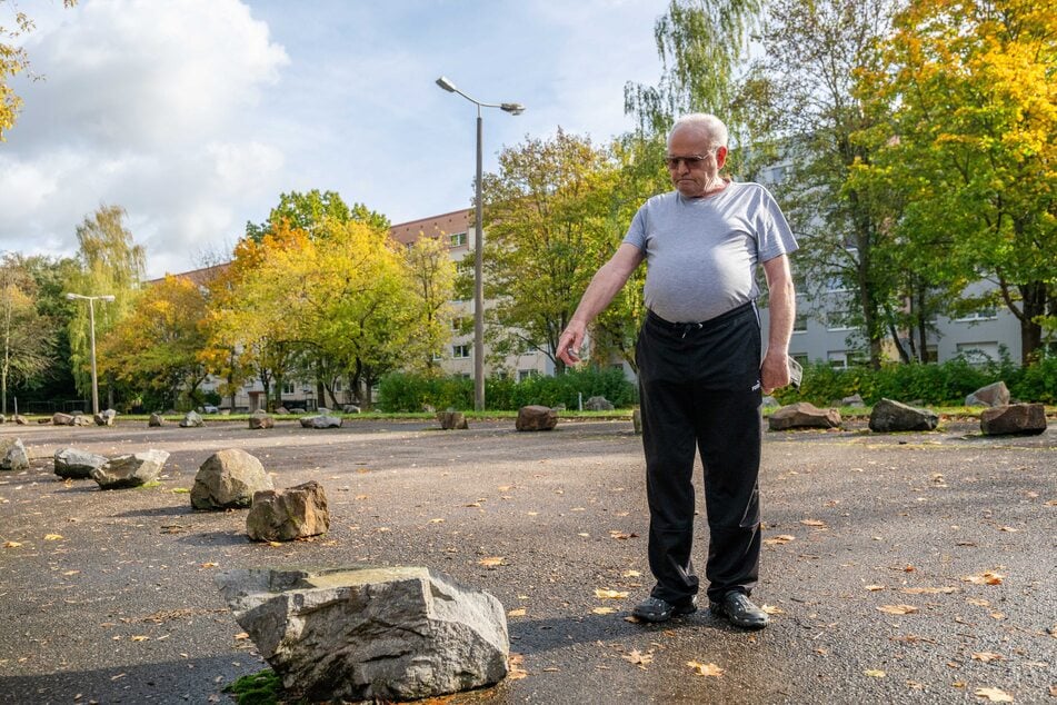 Roland Schirmer (87) zeigt auf den mit Steinen abgesperrten Mietstellplatz.