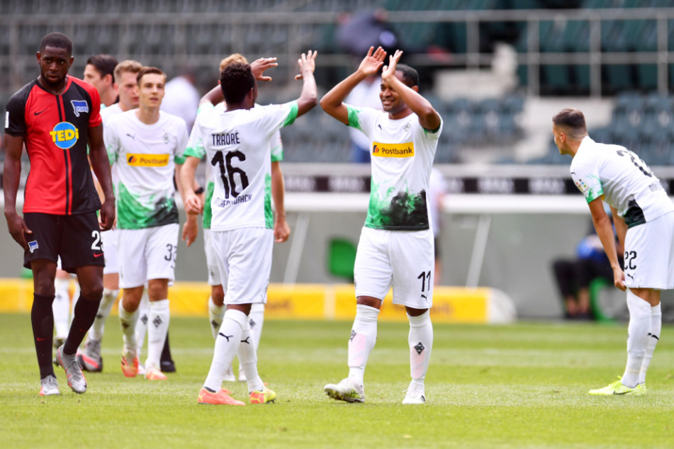 Zwei Ex-Herthaner jubeln nach Gladbachs Sieg gegen die "Alte Dame" über die Champions-League-Qualifikation: Ibrahima Traoré (Nr. 16) und Raffael (2.v.r.) klatschen einander ab.