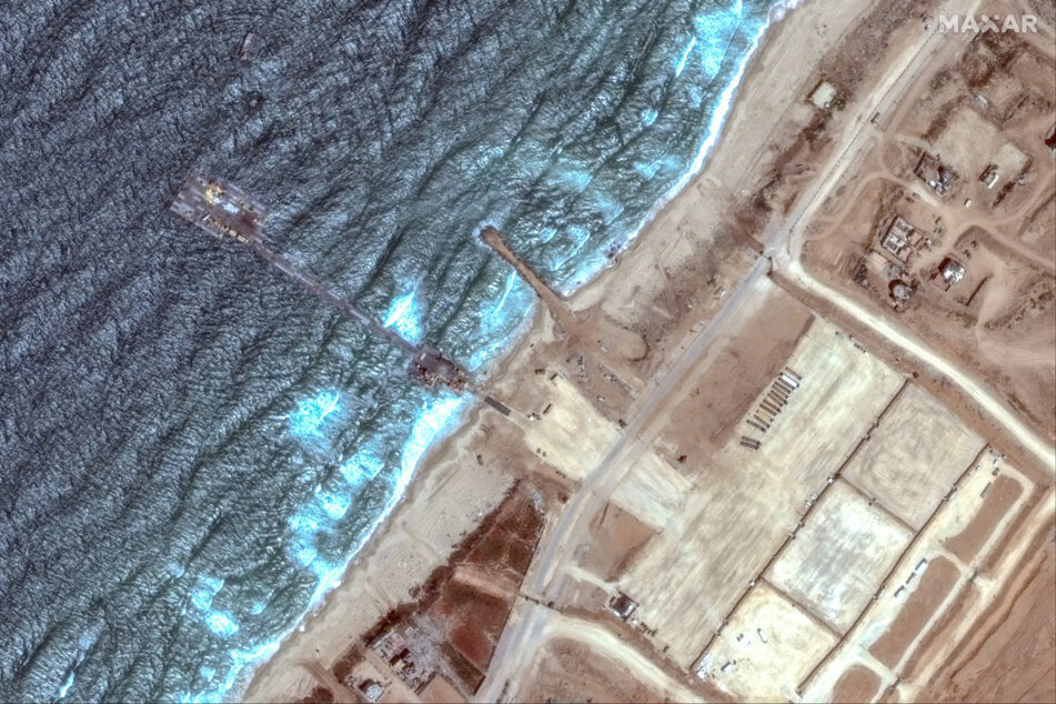 A satellite image shows an overview of the US-constructed temporary aid pier on the Gaza shoreline, which was damaged in severe weather.