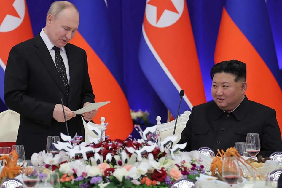 This picture taken on June 19, 2024 and released on June 20, 2024 from North Korea's official Korean Central News Agency (KCNA) via KNS shows Russia's President Vladimir Putin (center L) giving a speech next to North Korea's leader Kim Jong Un during his welcoming reception in Pyongyang.