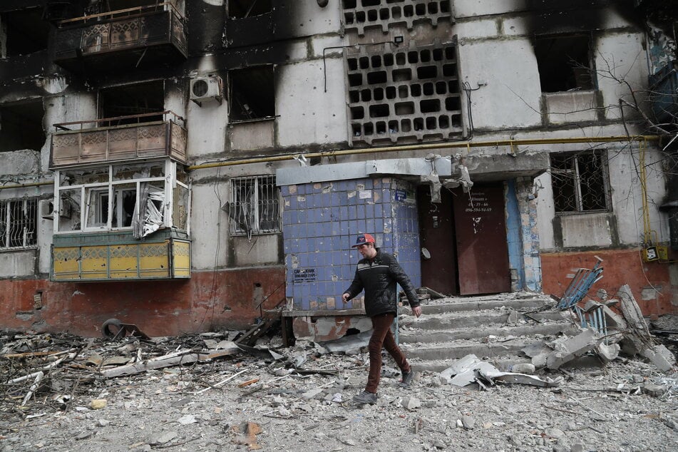 A man walks past a damaged building in Mariupol, Ukraine.