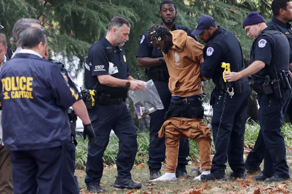 Capitol Police officers arrested Ahmir Lavon Merrell (c.) after he was spotted carrying a gun in the park between Union Station and a Senate building.