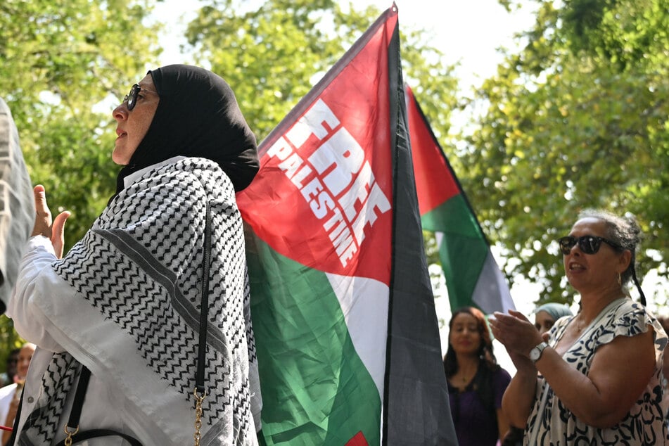 A demonstrator holds a flag reading "Free Palestine" during a rally at Bastille Square in Paris, France, on August 9, 2025.