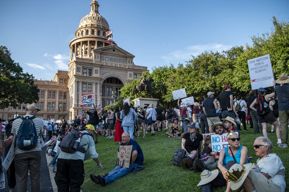 Demonstrators protest the Trump administration during the "No Kings" rally outside the State Capitol in Austin, Texas, on June 14, 2025.