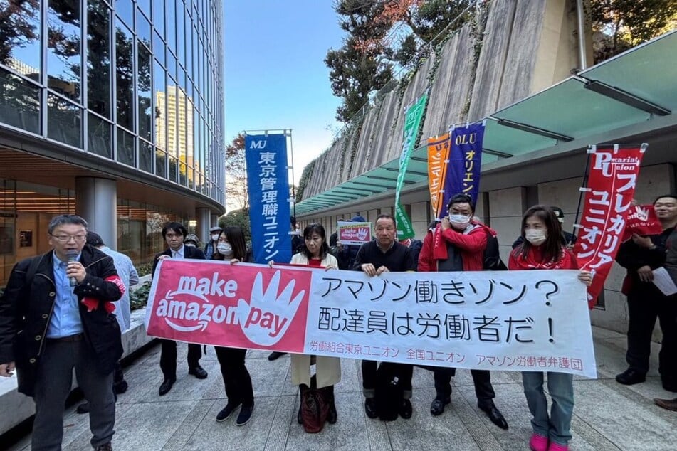 Delivery workers and campaigners demand Amazon improve workers’ conditions and drop its unmanageable quotas during a Black Friday action in Tokyo, Japan.