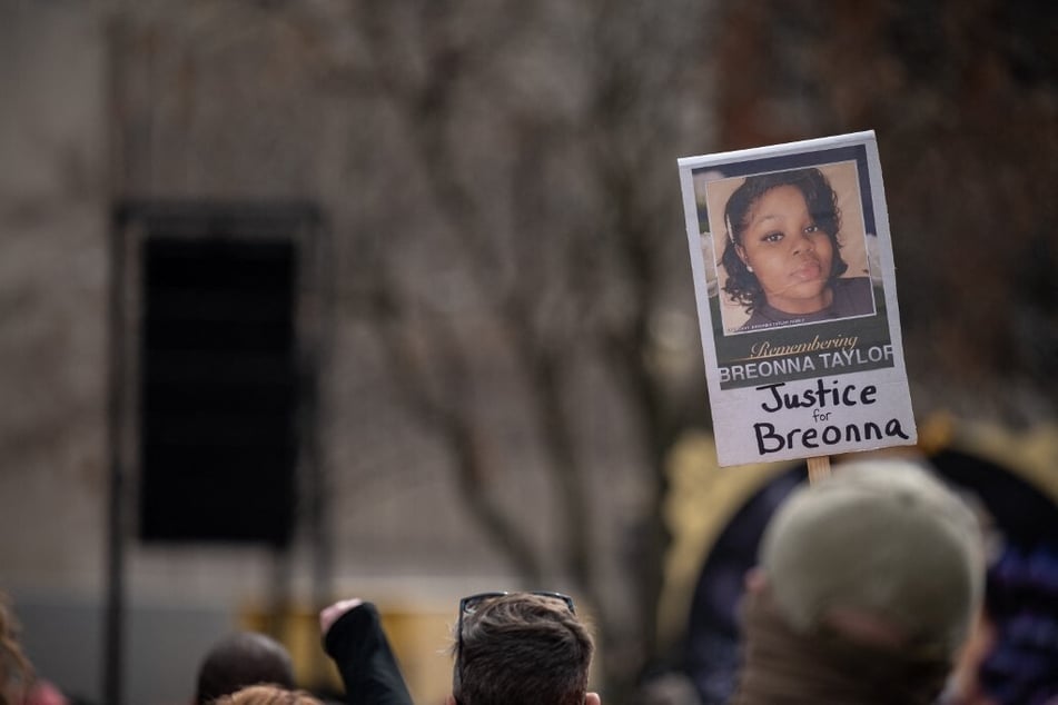 A sign demanding justice for Breonna Taylor is held up during memorial protest in her honor at Jefferson Square Park in Louisville, Kentucky, on March 13, 2021.