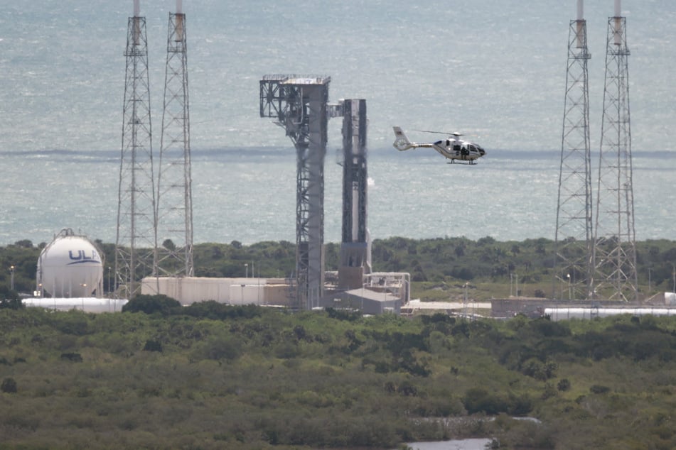 A security helicopter flies past Boeing’s Starliner spacecraft before its flight was scrubbed as it sits atop a United Launch Alliance Atlas V rocket at Space Launch Complex 41 on June 01, 2024, in Cape Canaveral, Florida.