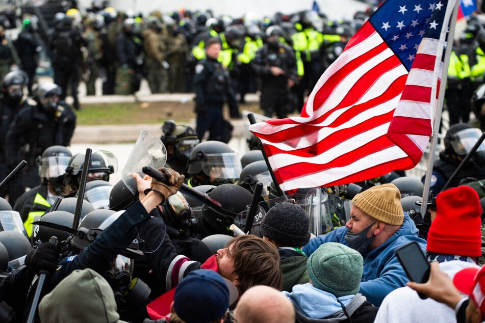 Supporters of US President Donald Trump fight with riot police outside the Capitol building on January 6, 2021 in Washington, DC.