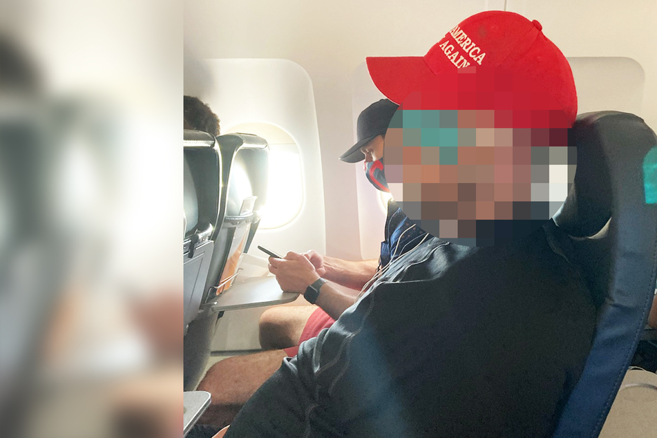 Typ im Flugzeug trägt Mund-Nasen-Maske komplett falsch