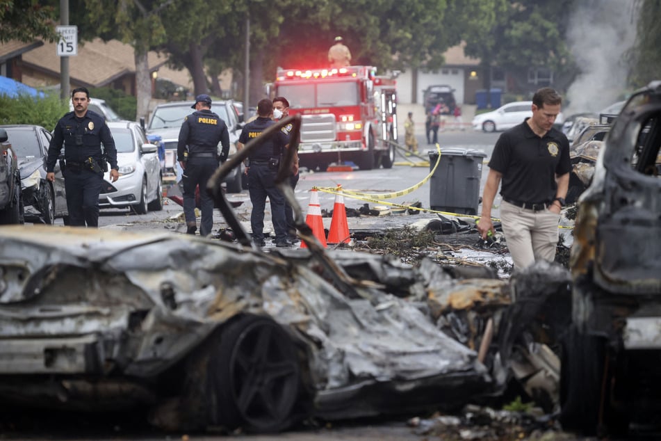 Investigators look through the site where a small plane crashed into a San Diego, California residential street on Thursday, The Federal Aviation Authority said.