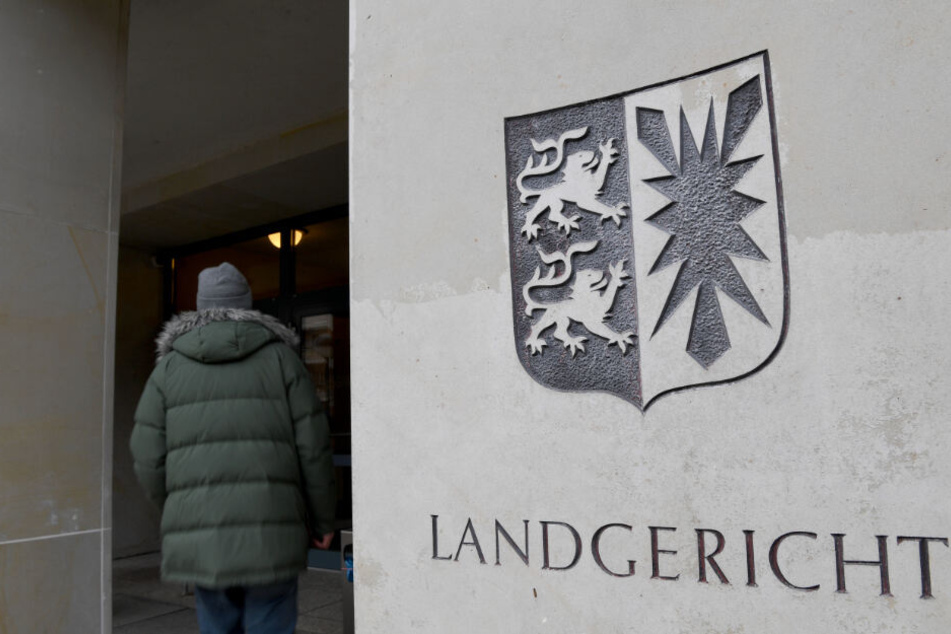 Ein Mann geht in das Landgericht in Kiel. Dort findet der Prozess wegen Schüssen auf der Autobahn statt.