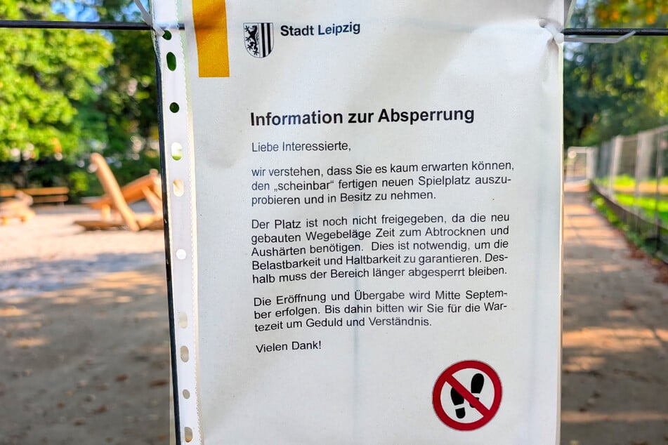 Ein Aushang erklärt, wieso der augenscheinlich funktionstüchtige Spielplatz noch nicht betreten werden darf.